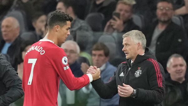 Manchester United's Cristiano Ronaldo, left, greets Manchester United's manager Ole Gunnar Solskjaer as he is replaced by Manchester United's Marcus Rashford during the English Premier League soccer match between Tottenham Hotspur and Manchester United at the Tottenham Hotspur Stadium in London, Saturday, Oct. 30, 2021 - Sputnik International