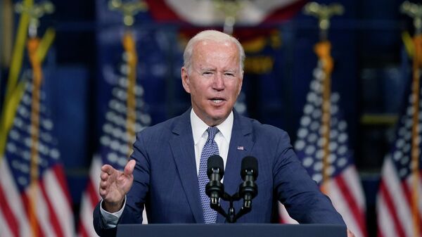 In this Oct. 25, 2021, photo, President Joe Biden speaks at NJ Transit Meadowlands Maintenance Complex to promote his economic agenda in Kearny, N.J. Biden promised to show the world that democracies can work to meet the challenges of the 21st century - Sputnik International