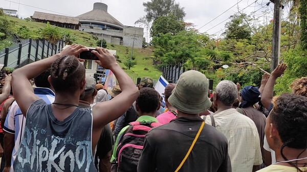 Protestors gather outside the parliament building in Honiara, Solomon Islands, November 24, 2021, in this screen grab obtained by Reuters, from a social media video - Sputnik International