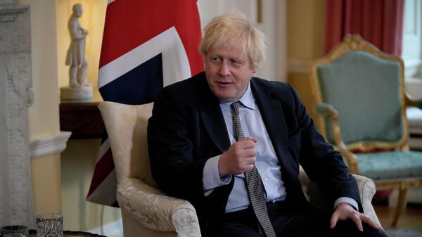 British Prime Minister Boris Johnson speaks with Polish Prime Minister Mateusz Morawiecki at the start of their meeting inside 10 Downing Street, in London, Friday, Nov. 26, 2021 - Sputnik International