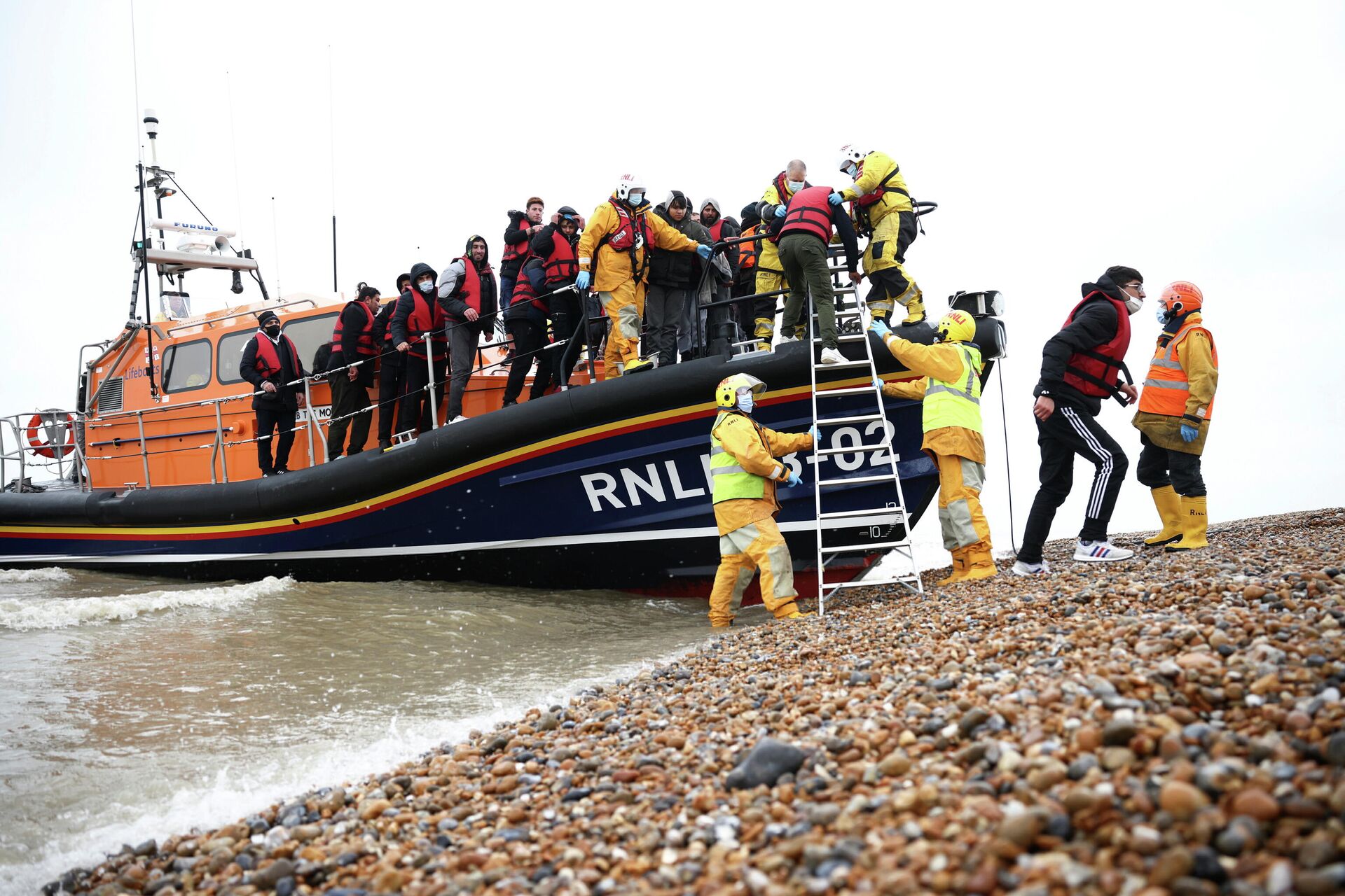 Migrants are brought ashore onboard a RNLI Lifeboat, after having crossed the channel, in Dungeness, Britain, November 24, 2021 - Sputnik International, 1920, 03.12.2021