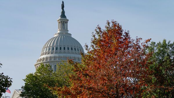 The U.S. Capitol is seen past fall foliage, Thursday, Oct. 28, 2021, on Capitol Hill in Washington. - Sputnik International