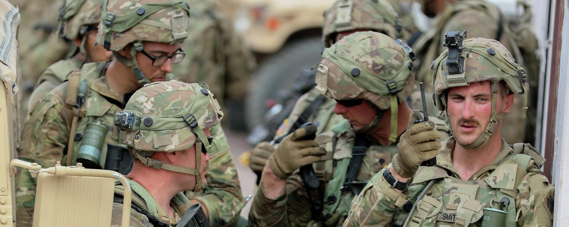 Soldiers with the 45th Infantry Brigade Combat Team, Oklahoma Army National Guard, stand in formation preparing to move towards a safehouse during a training exercise at the National Training Center in Fort Irwin, California, July 21, 2021. Members of the 45th IBCT are participating in the Battle of Razish located in a mock-town that simulates a war-like experience and includes a fight from the on post opposing force with the intent of increasing readiness among Soldiers.  - Sputnik International, 1920, 03.12.2021