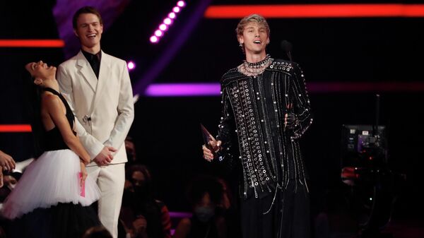 Machine Gun Kelly receives an award for Favourite Music Artist next to Rachel Zegler and Ansel Elgort at the Annual American Music Awards at the Microsoft Theatre in Los Angeles, California, US, on 21 November 2021. - Sputnik International