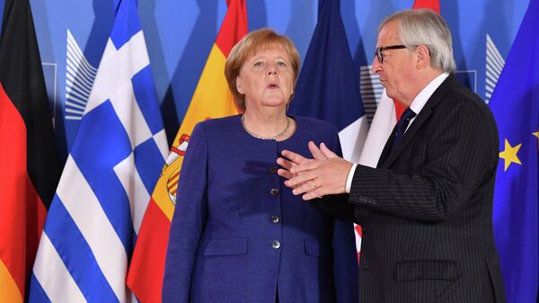 European Commission President Jean-Claude Juncker, right, speaks with German Chancellor Angela Merkel during an informal EU summit on migration at EU headquarters in Brussels, Sunday, June 24, 2018. (AP Photo/Geert Vanden Wijngaert, Pool) - Sputnik International