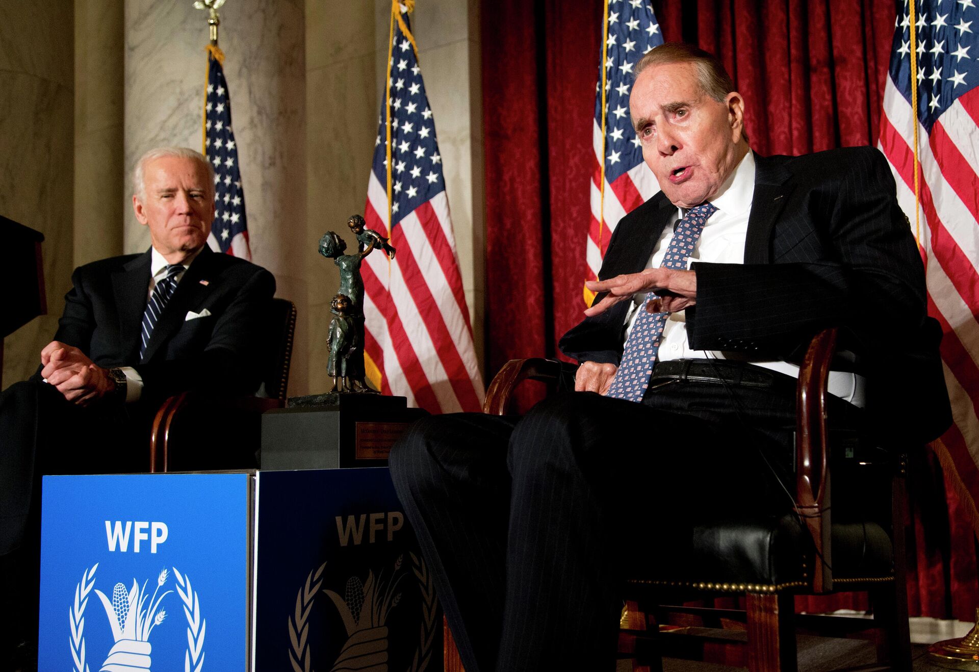 In this Dec. 11, 2013, file photo former Senate Majority Leader Bob Dole, right, speaks after being presented with the McGovern-Dole Leadership Award by Vice President Joe Biden, left, to honor his leadership in the fight against hunger, during the 12th Annual George McGovern Leadership Award Ceremony hosted by World Food Program USA, on Capitol Hill in Washington.  - Sputnik International, 1920, 05.12.2021