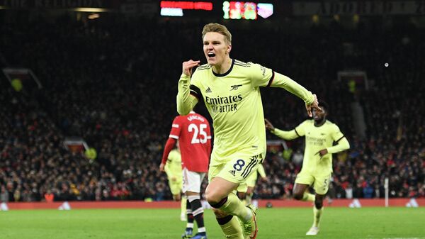 Arsenal's Norwegian midfielder Martin Odegaard celebrates after scoring their second goal during the English Premier League football match between Manchester United and Arsenal at Old Trafford in Manchester, north west England, on December 2, 2021. - Sputnik International