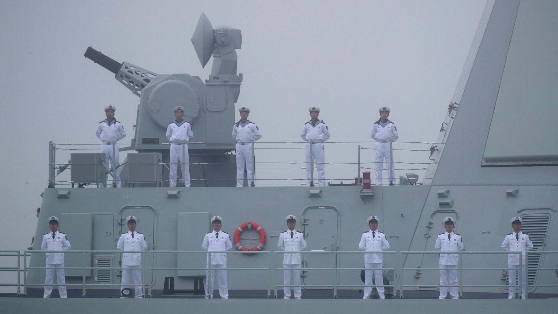 Sailors stand on the deck of the new type 055 guided-missile destroyer Nanchang of the Chinese People's Liberation Army (PLA) Navy as it participates in a naval parade to commemorate the 70th anniversary of the founding of China's PLA Navy in the sea near Qingdao in eastern China's Shandong province, Tuesday, April 23, 2019 - Sputnik International, 1920, 01.08.2022