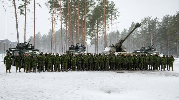 Canadian military troops stand guard for a picture at the Adazi military base, Latvia on November 29, 2021 - Sputnik International