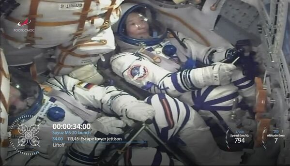 In this photo taken from video footage released by the Roscosmos Space Agency, Roscosmos cosmonaut Alexander Misurkin, bottom, and spaceflight participant Yusaku Maezawa, of Japan, above, are seen inside the spaceship as the Soyuz-2.1a rocket booster blasts off from the Baikonur cosmodrome.  - Sputnik International