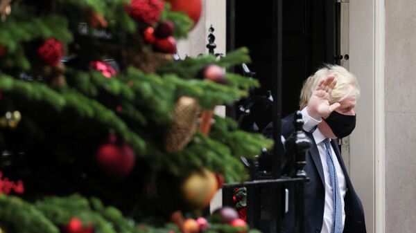 Britain's Prime Minister Boris Johnson waves outside Downing Street in London, Britain, December 8, 2021.  - Sputnik International