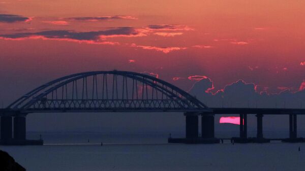A general view shows a road-and-rail bridge, which is constructed to connect the Russian mainland with the Crimean peninsula, during sunrise in the Kerch Strait, Crimea April 3, 2019. - Sputnik International