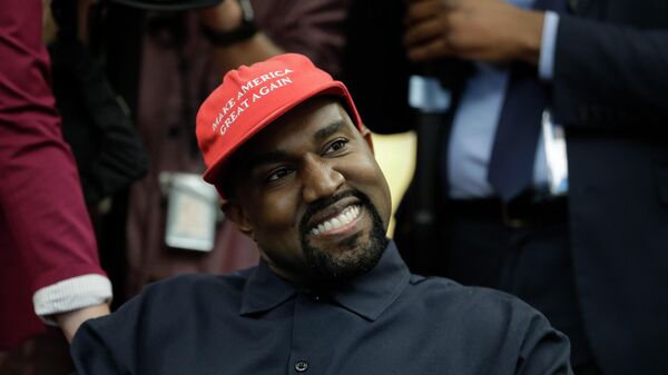Rapper Kanye West wears a Make America Great again hat during a meeting with President Donald Trump in the Oval Office of the White House in Washington on Oct. 11, 2018. - Sputnik International