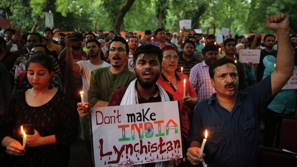 Indian protesters shout slogans as they hold placards and candles during a protest condemning recent mob lynching of Muslim youth Tabrez Ansari in Jharkhand state, in New Delhi, India, Wednesday, June 26, 2019. Since Prime Minister Narendra Modi took the helm of the Indian government, Hindu mobs have lynched dozens of people, mainly Muslims and lower-caste Dalits. - Sputnik International
