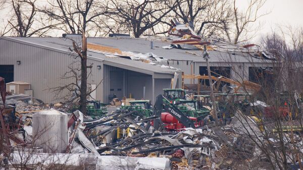 General view of the collapsed Mayfield Consumer Products (foreground) where workers were present when the tornado came through Friday night on 11 December 2021 in Mayfield, Kentucky. - Sputnik International