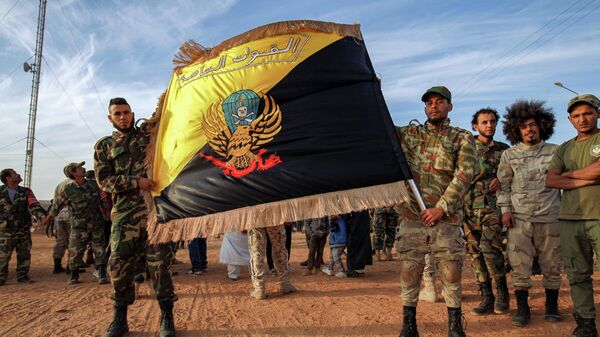 Members of the the Saiqa (Special Forces) of the self-proclaimed Libyan National Army (LNA), loyal to eastern strongman Khalifa Haftar, pose with their flag during an event in tribute to the unit's late commander General Wanis Bukhamada, who died a week prior, in the eastern city of Benghazi on November 6, 2020.  - Sputnik International