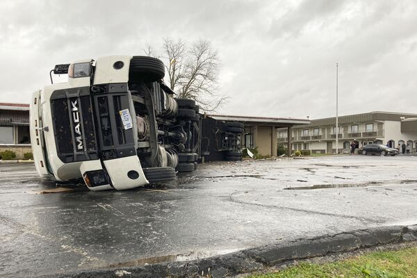 A large semi-trailer is flipped over and pushed against a building in Bowling Green, KY, on Saturday, 11 December 2021. - Sputnik International