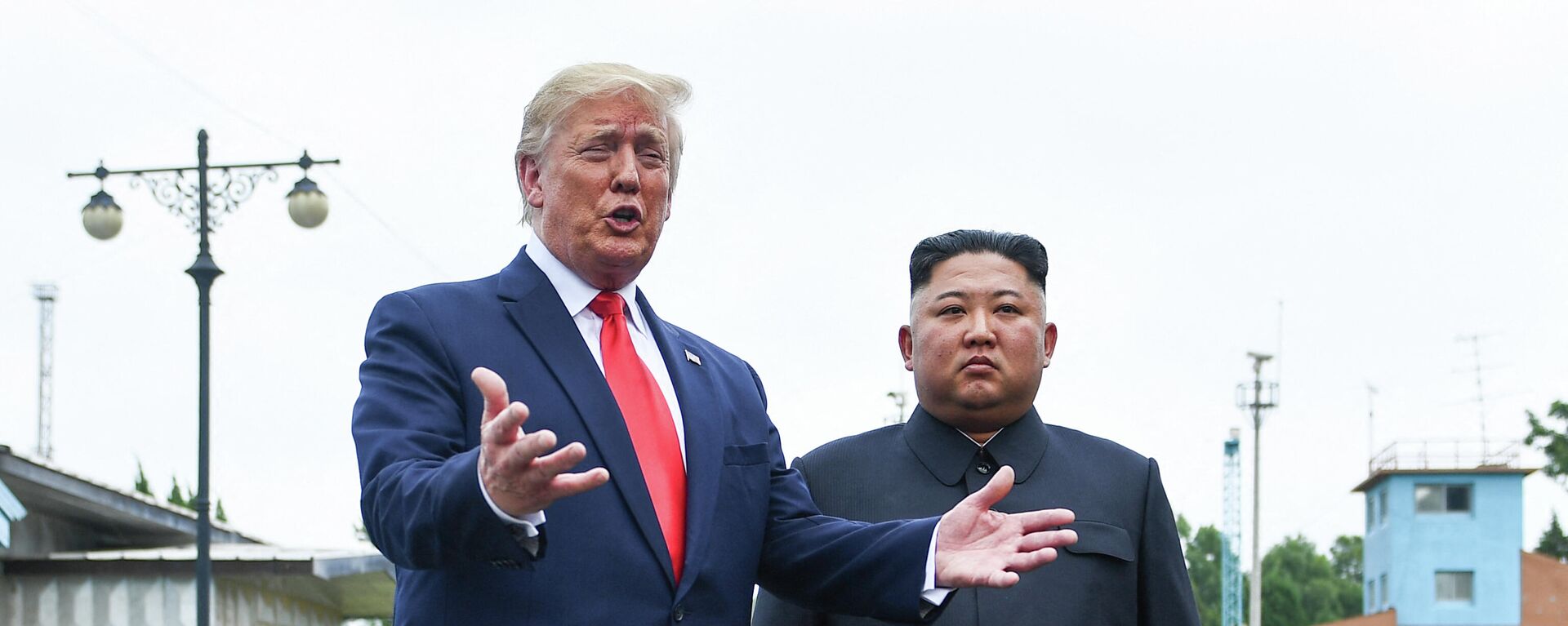 US President Donald Trump speaks as he stands with North Korea's leader Kim Jong Un south of the Military Demarcation Line that divides North and South Korea, in the Joint Security Area (JSA) of Panmunjom in the Demilitarized zone (DMZ) on June 30, 2019 - Sputnik International, 1920, 12.12.2021