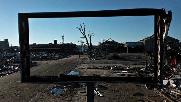 Tornado damage is seen after extreme weather hit the region December 12, 2021, in Mayfield, Kentucky. - Dozens of devastating tornadoes roared through five US states overnight, leaving more than 80 people dead on December 11, 2021 in what President Joe Biden said was one of the largest storm outbreaks in history. - Sputnik International