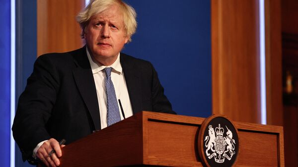 Britain's Prime Minister Boris Johnson holds a press conference for the latest Covid-19 update in the Downing Street briefing room in central London on December 8, 2021 - Sputnik International