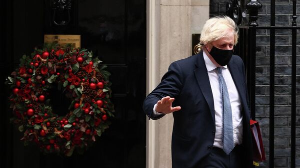 Britain's Prime Minister Boris Johnson, wearing a face covering to stop the spread of coronavirus, leaves from 10 Downing Street in central London on December 8, 2021 - Sputnik International