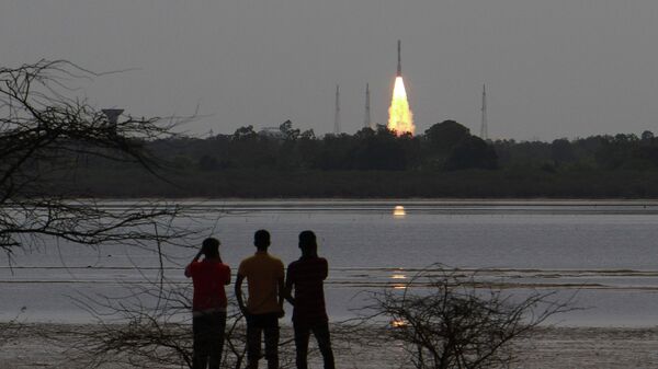 People watch as Indian Space Research Organization (ISRO)'s Polar Satellite Launch Vehicle carrying the 712 kg Cartosat-2 Series Satellite along with 30 co-passenger satellites, blasts off from the Satish Dhawan Space Centre at Sriharikota in Andhra Pradesh, around 117 kilometers (72 miles) north east of Chennai, India, Friday, June 23, 2017 - Sputnik International