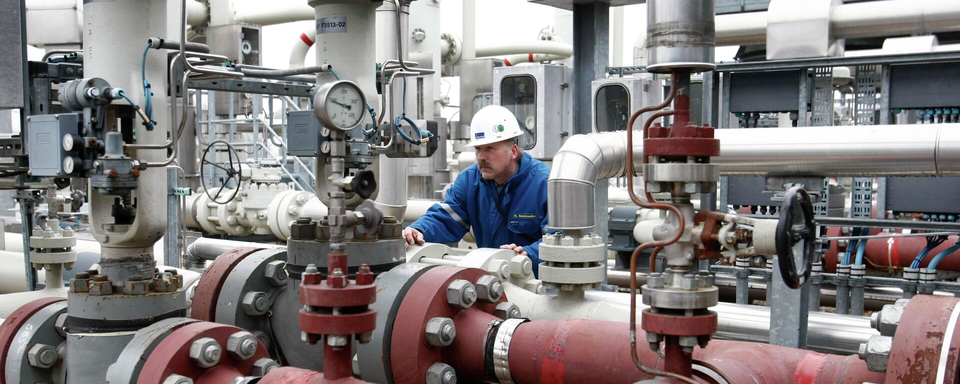 A worker inspects parts of the largest gas storage facility of Western Europe in Rehden, northern Germany - Sputnik International, 1920, 24.04.2022