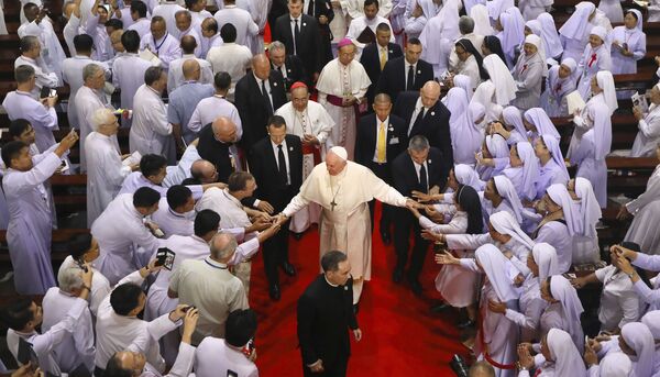 Priests, religious seminarians and Catechists touch the hands of Pope Francis as he leaves after meeting them at Saint Peter's Parish on the outskirts of Bangkok, Thailand, Friday, 22 November 2019. - Sputnik International