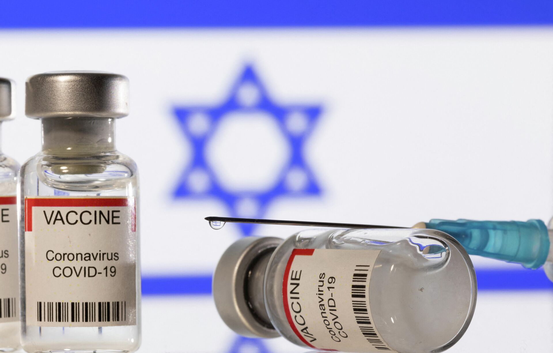 Vials labelled VACCINE Coronavirus COVID-19 and a syringe are seen in front of a displayed flag of Israel in this illustration taken December 11, 2021. - Sputnik International, 1920, 29.12.2021