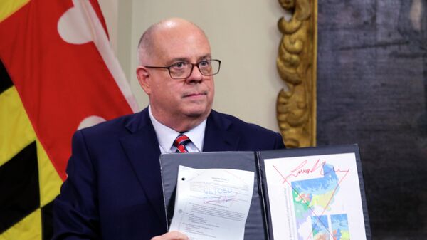 Maryland's Republican Gov. Larry Hogan shows a copy of the redrawn congressional map approved by the General Assembly this week, that is crossed out in red, during a news conference where he announced his veto of the plan, Thursday, Dec. 9, 2021, in Annapolis, Md. - Sputnik International