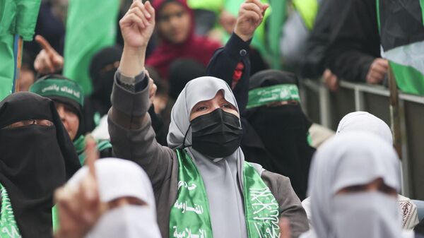 Palestinians take part in a rally marking the 34th anniversary of the founding of Hamas, in Gaza City, 17 December 2021. - Sputnik International