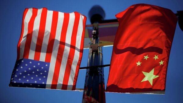 The flags of the United States and China fly from a lamppost in the Chinatown neighborhood of Boston, Massachusetts, U.S., November 1, 2021. - Sputnik International