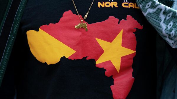 Angesom Mezgebo, wears a T shirt and a pendent, with images of map of Tigray during a protest march to mark a year since Ethiopia Prime Minister Abiy Ahmed's administration started fighting against the Tigray, the northernmost region in Ethiopia,Thursday, Nov. 4, 2021 in Washington. - Sputnik International