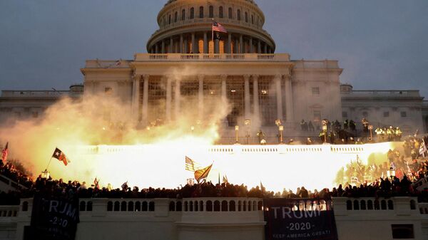An explosion caused by a police munition is seen while supporters of U.S. President Donald Trump riot in front of the U.S. Capitol Building in Washington, U.S., January 6, 2021 - Sputnik International