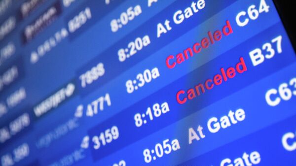 A screen showing cancelled flights is seen at John F. Kennedy International Airport during the spread of the Omicron coronavirus variant in Queens, New York City, U.S., December 26, 2021. - Sputnik International
