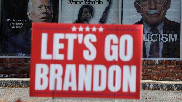 A Let's Go Brandon sign stands in front of posters advocating against gun control and depicting U.S. President Joe Biden, U.S. Senator Dianne Feinstein and Dr. Anthony Fauci at the 619DW Guns and Ammo store in Merrimack, New Hampshire, U.S., November 29, 2021.  - Sputnik International