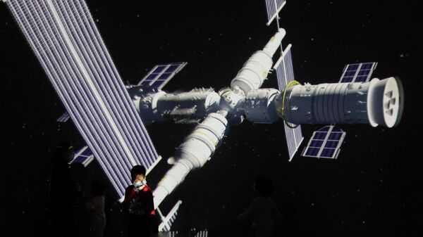 A child stands near a giant screen showing the image of the Tianhe space station on the country's Space Day at China Science and Technology Museum in Beijing, China April 24, 2021 - Sputnik International