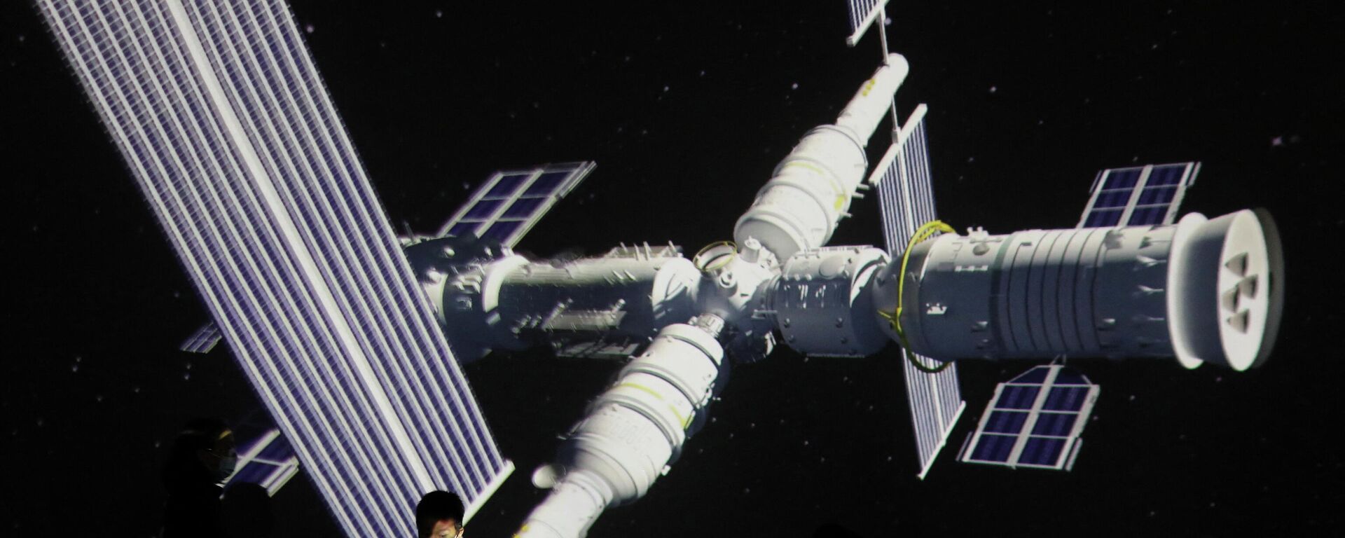 A child stands near a giant screen showing the image of the Tianhe space station on the country's Space Day at China Science and Technology Museum in Beijing, China April 24, 2021 - Sputnik International, 1920, 27.12.2021