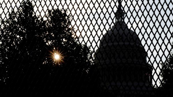 FILE PHOTO: The sun rises behind the U.S. Capitol, surrounded by a security fence ahead of an expected rally Saturday in support of the Jan. 6 defendants in Washington, U.S. September 16, 2021.  REUTERS/Jonathan Ernst/File Photo - Sputnik International