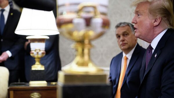 In this file photo taken on May 13, 2019 Hungary's Prime Minister Viktor Orban listens while US President Donald Trump speaks to the press before a meeting in the Oval Office of the White House in Washington, DC. - Sputnik International