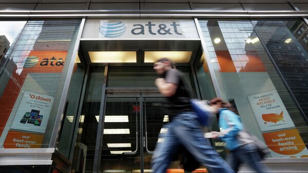 FILE - In this Oct. 21, 2014, file photo, people pass an AT&T store along New York's Madison Avenue. The nation's largest cellphone providers will pay a combined $116 million under a settlement approved Thursday, Sept. 24, 2020, in a California lawsuit alleging that they overcharged government customers for wireless services over more than a decade. Verizon will pay $68 million and AT&T Mobility $48 million to settle claims that they violated cost-saving agreements with nearly 300 state and local governments.  - Sputnik International