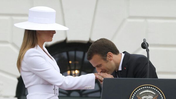 French President Emmanuel Macron kisses the hand of US First Lady Melania Trump during a state welcome at the White House in Washington, DC, on April 24, 2018.  - Sputnik International