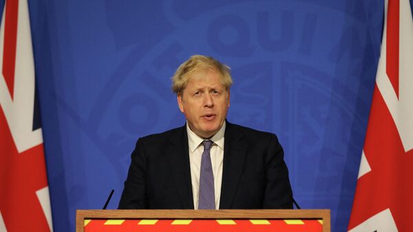Britain's Prime Minister Boris Johnson speaks during a virtual press conference to update the nation on the status of the Covid-19 pandemic, in the Downing Street briefing room in central London on January 4, 2022. - Sputnik International