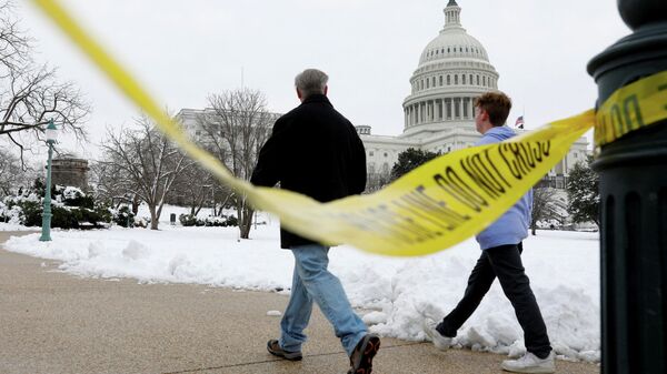Visitors walk beside yellow police tape on the eve of the first anniversary of the January 6, 2021 attack on the U.S. Capitol, on Capitol Hill in Washington - Sputnik International