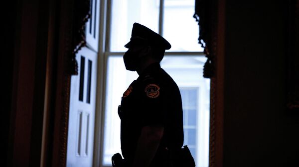 A U.S. Capitol police officer walks through the Capitol building on the eve of the first anniversary of the January 6, 2021 attack on the U.S. Capitol in Washington, U.S., January 5, 2022 - Sputnik International