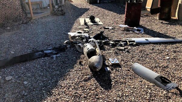 Parts of the wreckage of a drone are laid out on the ground near the Ain al-Asad airbase, in the western Anbar province of Iraq, Tuesday, Jan. 4, 2022. - Sputnik International