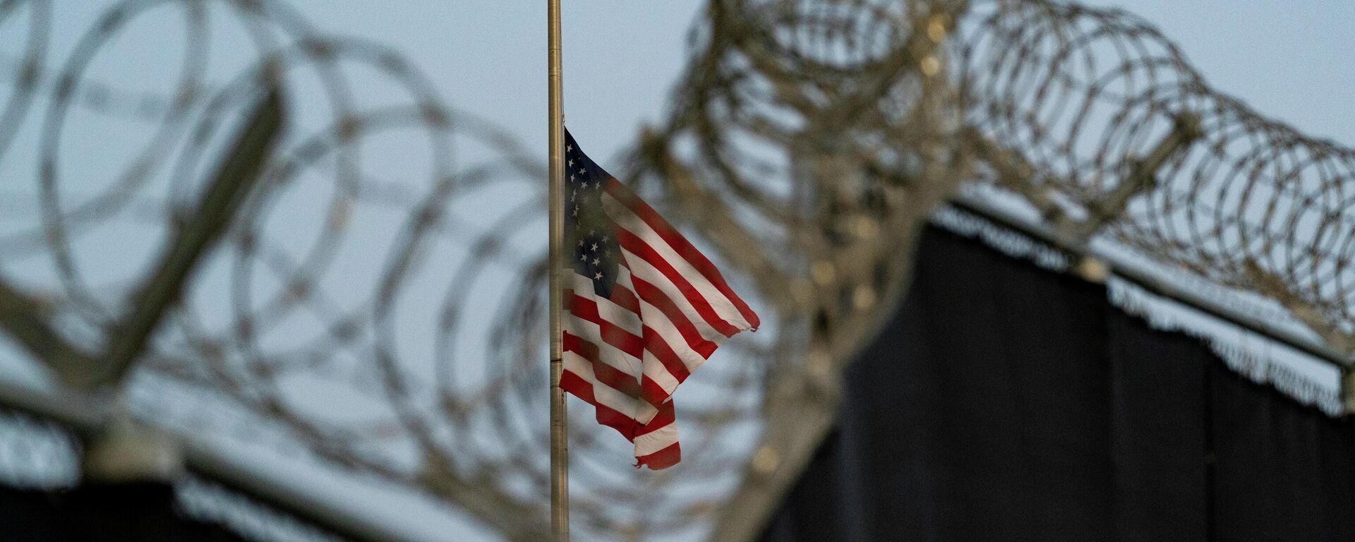 In this Aug. 29, 2021, file photo reviewed by U.S. military officials, a flag flies at half-staff in honor of the U.S. service members and other victims killed in the terrorist attack in Kabul, Afghanistan, as seen from Camp Justice in Guantanamo Bay Naval Base, Cuba. - Sputnik International, 1920, 10.01.2023