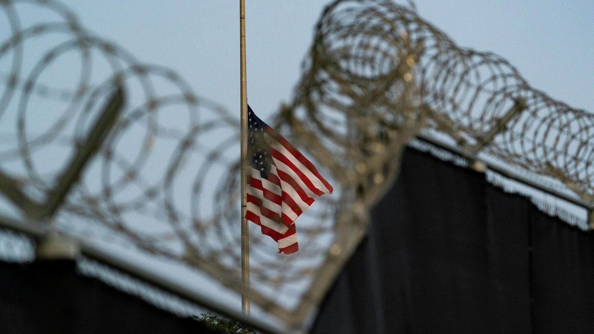 In this Aug. 29, 2021, file photo reviewed by U.S. military officials, a flag flies at half-staff in honor of the U.S. service members and other victims killed in the terrorist attack in Kabul, Afghanistan, as seen from Camp Justice in Guantanamo Bay Naval Base, Cuba. - Sputnik International, 1920, 12.01.2022