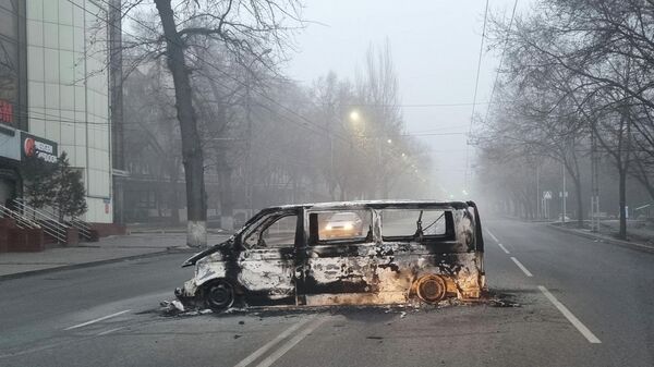 A vehicle that was burned during the protests triggered by fuel price increase is seen on a road in Almaty, Kazakhstan January 6, 2022. - Sputnik International
