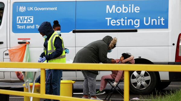 Members of the public use a an NHS Test and Trace mobile coronavirus testing unit in Hayes, Hillingdon, west London on May 24, 2021 - Sputnik International